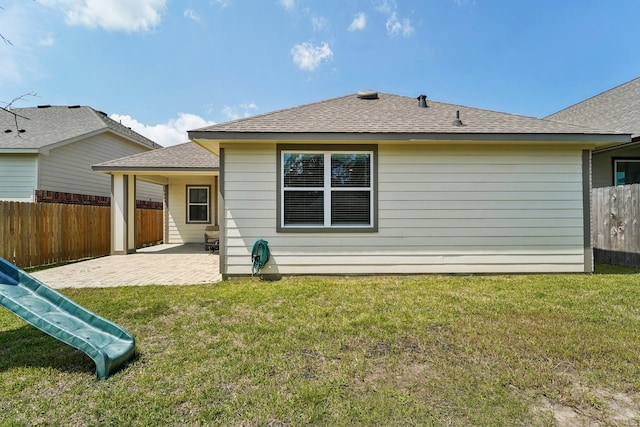 rear view of house featuring a patio and a yard