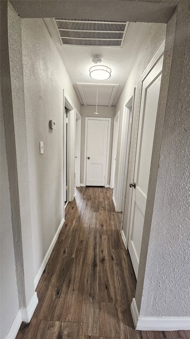 corridor featuring dark wood-type flooring