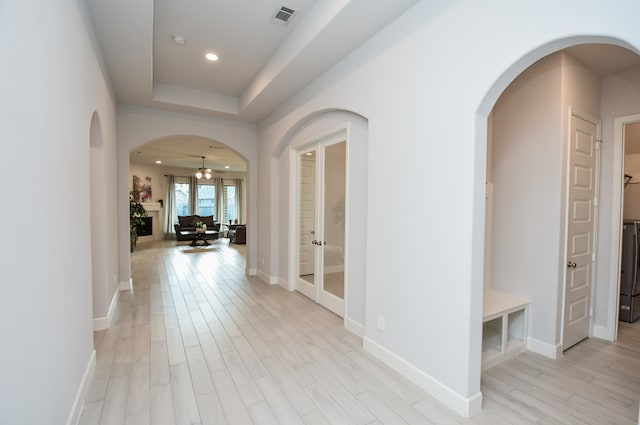 corridor with light hardwood / wood-style floors