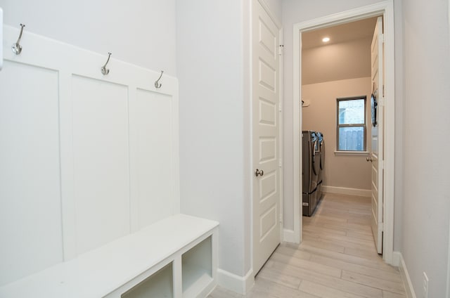 mudroom featuring separate washer and dryer and light hardwood / wood-style flooring