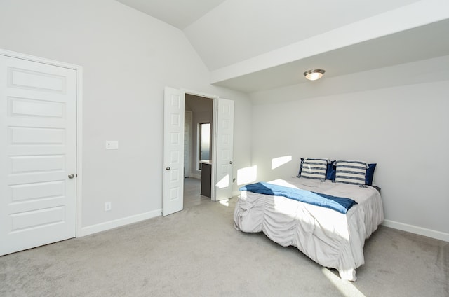 carpeted bedroom with lofted ceiling