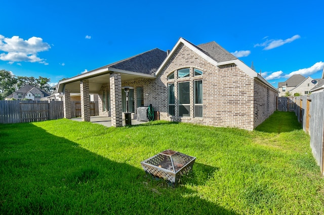 back of house with a lawn