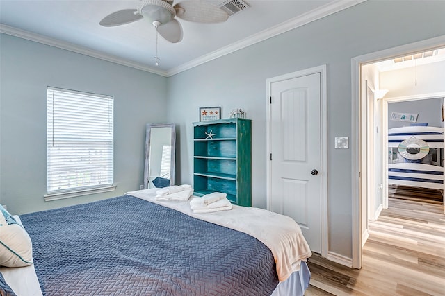 bedroom featuring ceiling fan, light hardwood / wood-style floors, and ornamental molding