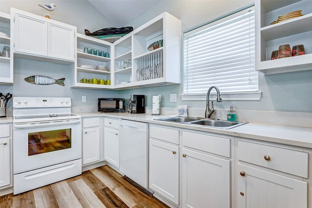 kitchen featuring white cabinets, vaulted ceiling, white appliances, light hardwood / wood-style floors, and sink