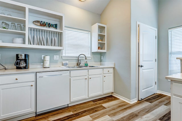 kitchen with light hardwood / wood-style flooring, dishwasher, white cabinetry, and sink