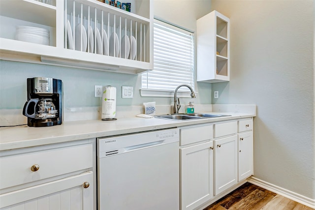 kitchen with dishwasher, dark hardwood / wood-style flooring, sink, and white cabinets