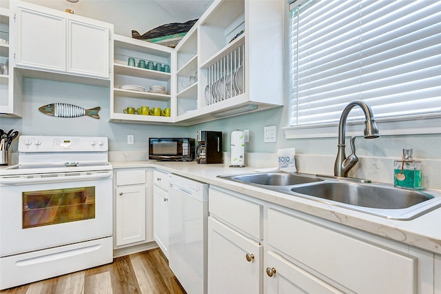 kitchen with white appliances, light hardwood / wood-style floors, white cabinetry, and sink