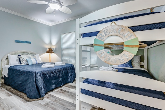 bedroom with ceiling fan, ornamental molding, and hardwood / wood-style floors