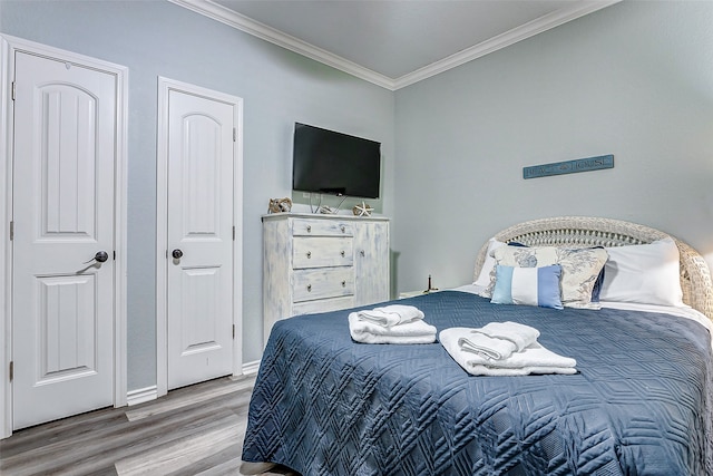 bedroom featuring ornamental molding and hardwood / wood-style floors