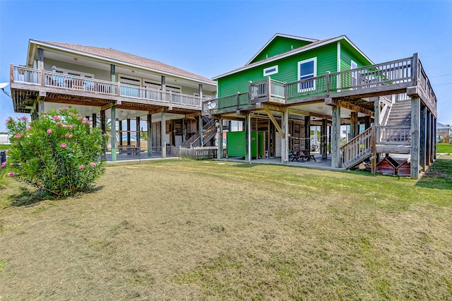 back of property with a yard, a patio, and a deck