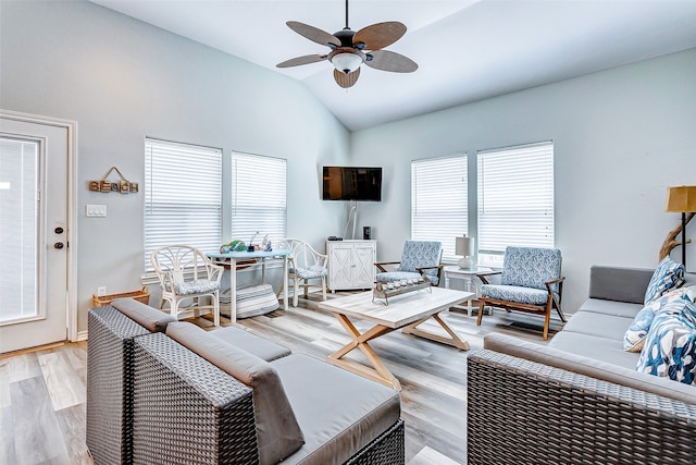 living room with light wood-type flooring, ceiling fan, and lofted ceiling