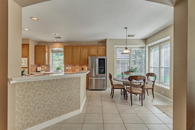 kitchen featuring decorative light fixtures, visible vents, light countertops, smart refrigerator, and white microwave