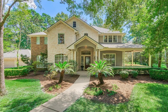 14851 Old Conroe Rd, Conroe, TX 77384 - view of front of home featuring a porch and stone siding