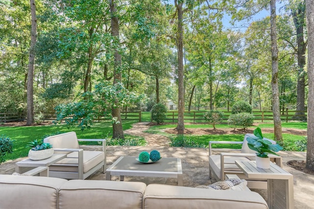 view of patio featuring outdoor lounge area and fence