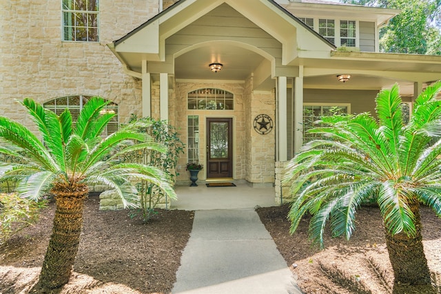 doorway to property featuring stone siding