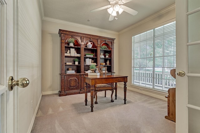 office area with a ceiling fan, light colored carpet, crown molding, and baseboards