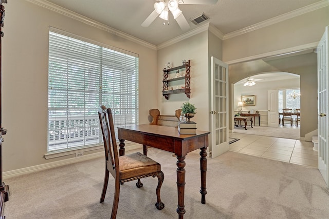 home office with visible vents, arched walkways, french doors, and light colored carpet