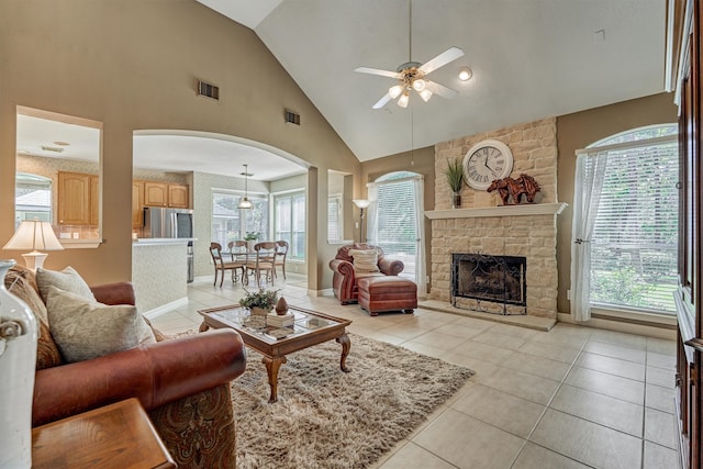 living area with visible vents, a fireplace, and light tile patterned floors