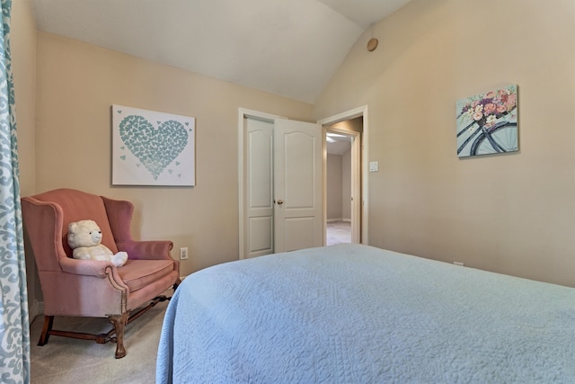 bedroom featuring vaulted ceiling and carpet flooring