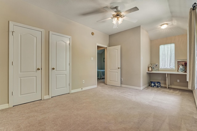 unfurnished bedroom featuring baseboards, a ceiling fan, and light colored carpet