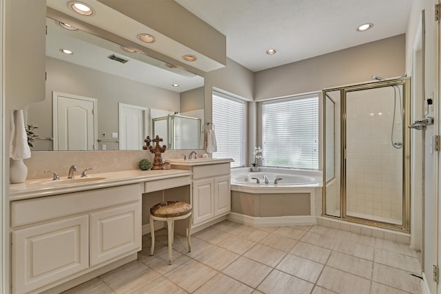 bathroom with a sink, visible vents, a bath, double vanity, and a stall shower