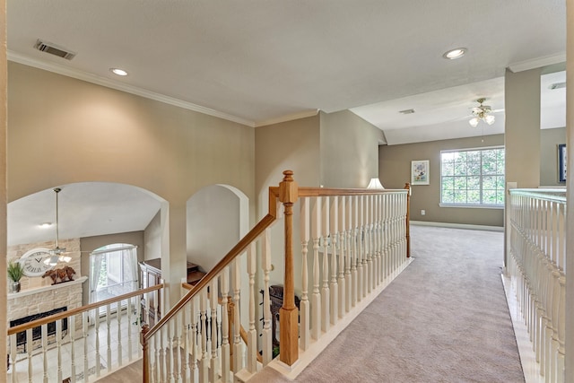 hallway featuring crown molding, visible vents, light carpet, an upstairs landing, and baseboards