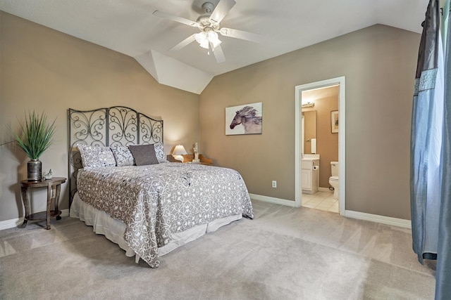 bedroom with light colored carpet, vaulted ceiling, baseboards, and ceiling fan