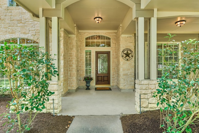 doorway to property featuring stone siding