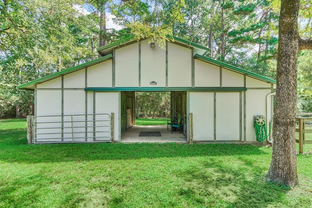 view of outbuilding featuring an outbuilding, an attached carport, and an exterior structure