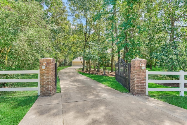 view of gate with a fenced front yard