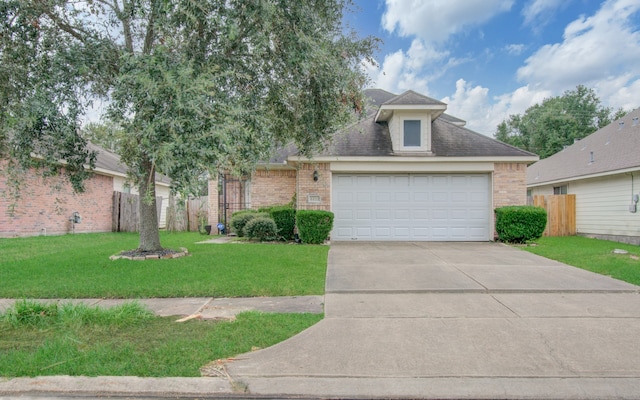 view of front of home featuring a garage and a front yard