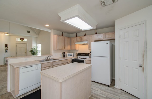 kitchen featuring a kitchen island, light brown cabinets, white appliances, and light hardwood / wood-style floors