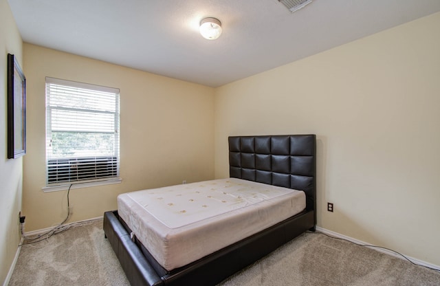 bedroom featuring light colored carpet