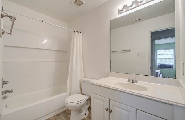 full bathroom with vanity, toilet, hardwood / wood-style floors, and shower / bath combo with shower curtain