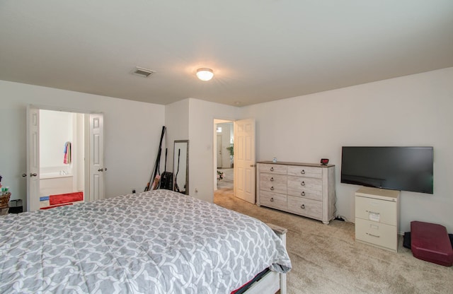 carpeted bedroom featuring ensuite bathroom