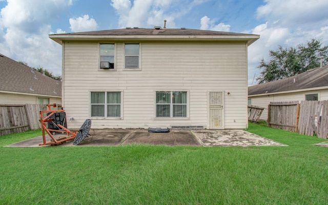 rear view of house with a patio area and a yard