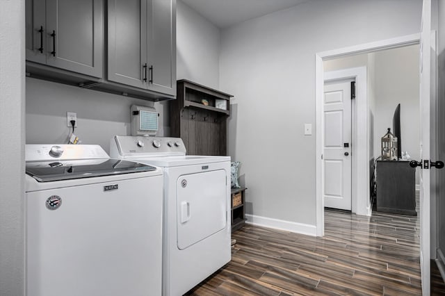 washroom featuring washer and clothes dryer, cabinets, and dark wood-type flooring