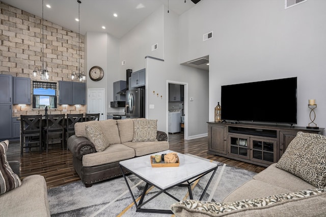 living room featuring ceiling fan, dark hardwood / wood-style floors, and high vaulted ceiling