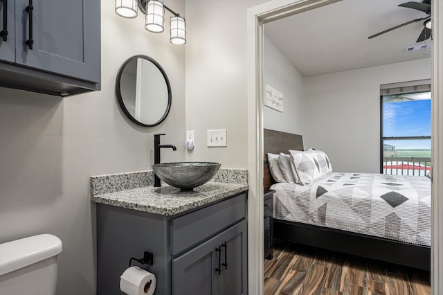 bedroom with sink, dark wood-type flooring, and ceiling fan