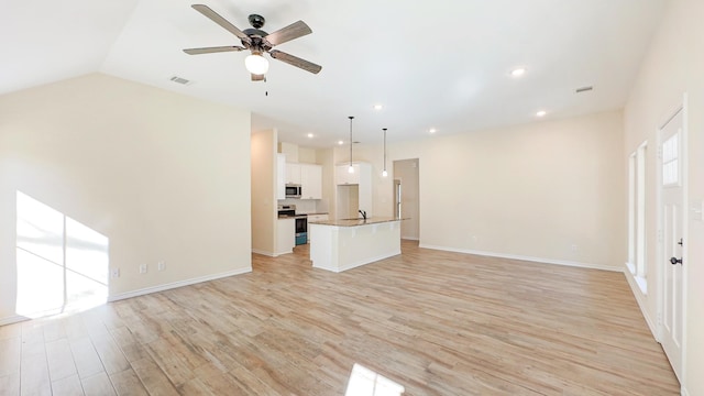 unfurnished living room featuring light wood-type flooring, lofted ceiling, sink, and ceiling fan