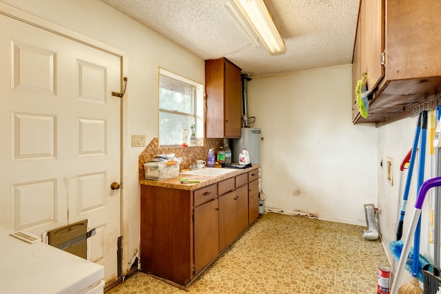 kitchen with a textured ceiling and sink