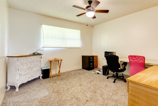 carpeted home office with ceiling fan and a textured ceiling