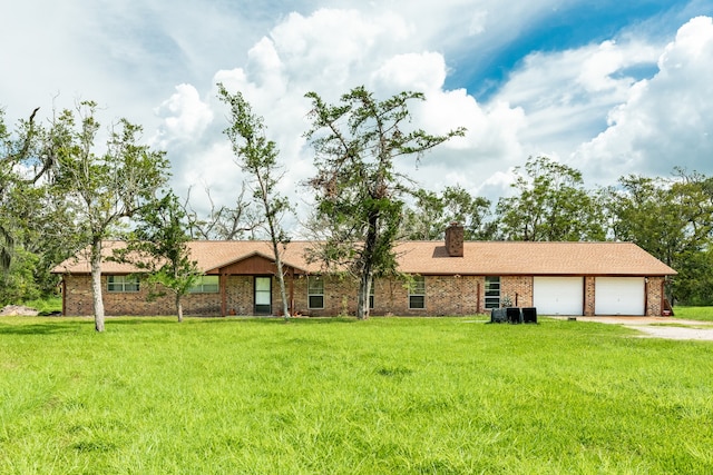 ranch-style house featuring a garage and a front yard