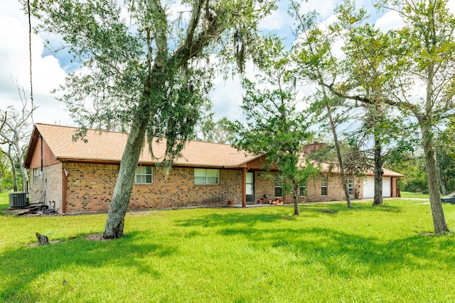 exterior space featuring a front yard and central AC unit