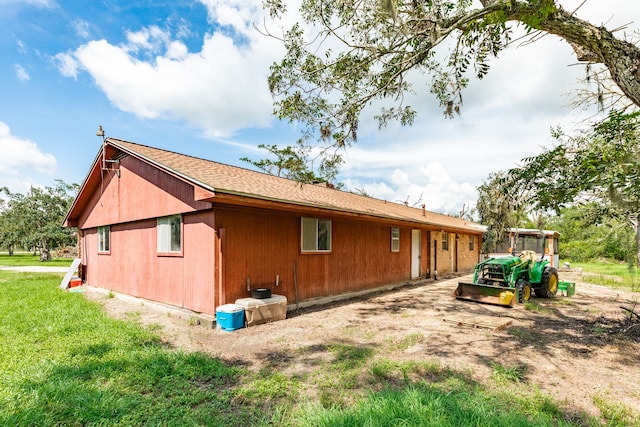 rear view of house featuring a yard