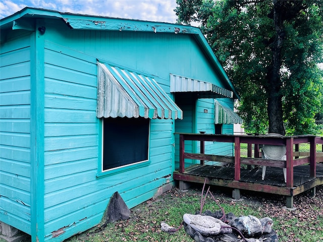 view of side of property featuring a deck