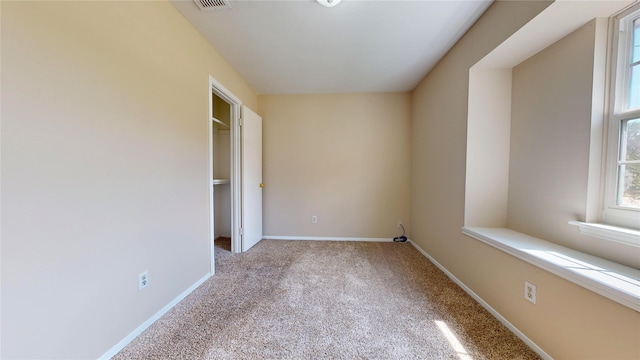 unfurnished bedroom with light colored carpet