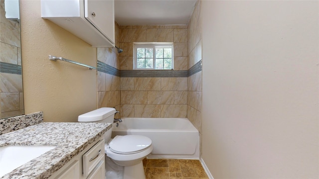 full bathroom with vanity, tiled shower / bath combo, and toilet