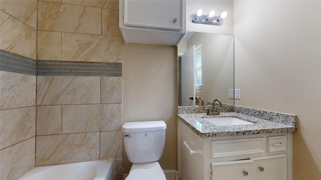 bathroom featuring a bathtub, vanity, and toilet