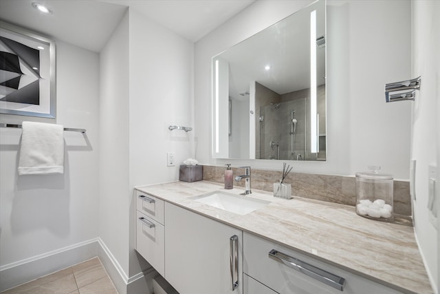 bathroom featuring vanity, tile patterned flooring, and a shower with door